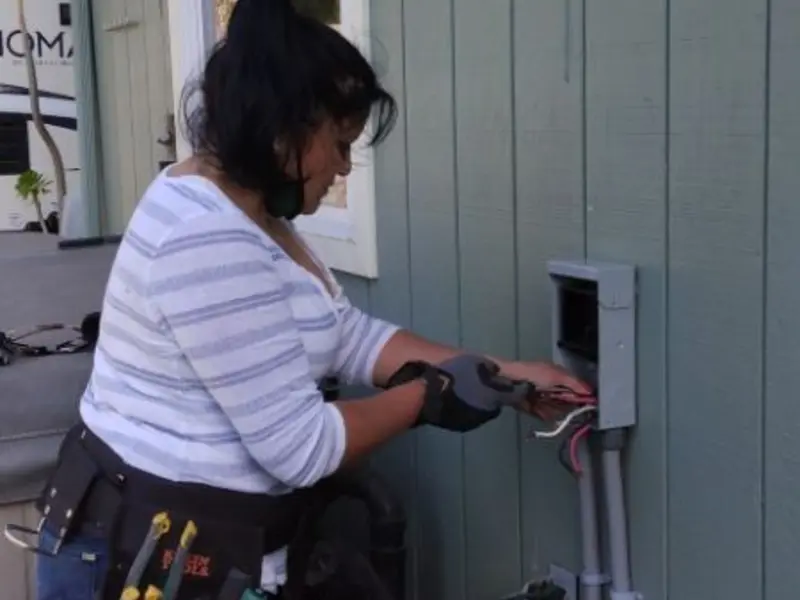 Licensed electrician wiring an exterior subpanel in New Bern